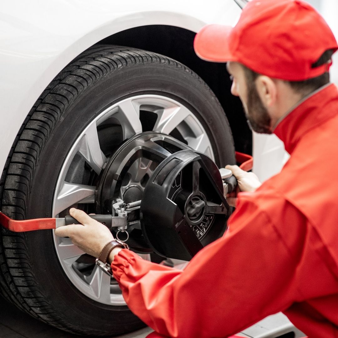 Wheel alignment service by a auto repair mechanic